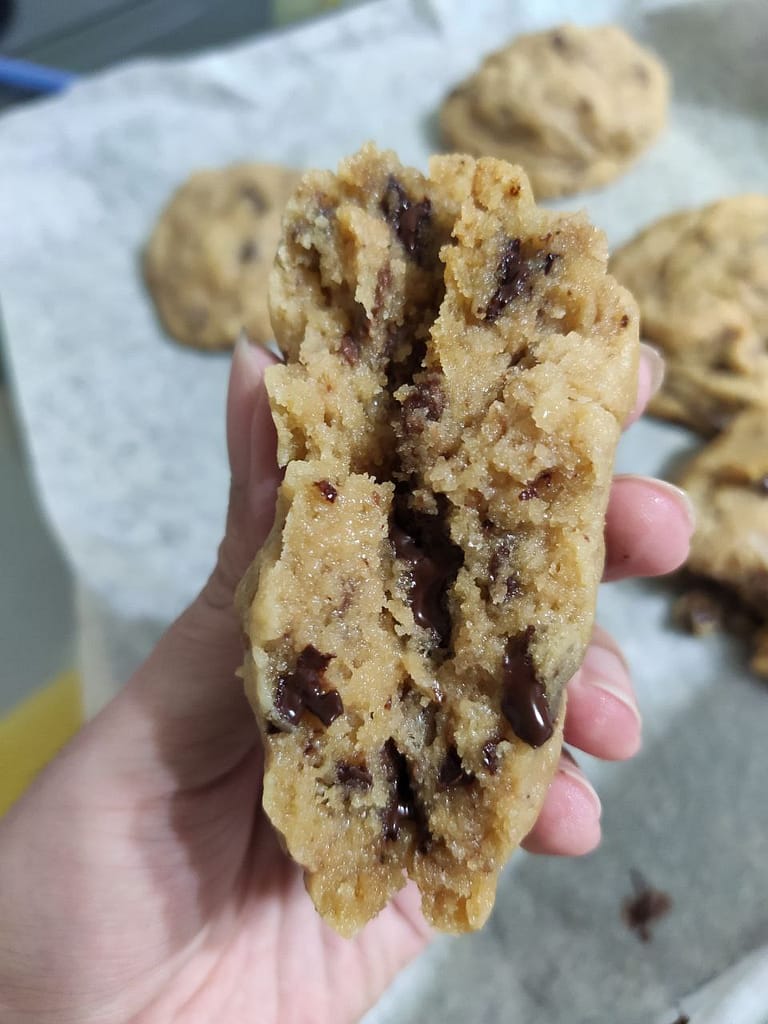 Gooey filling of NYC Chocolate Chip cookie